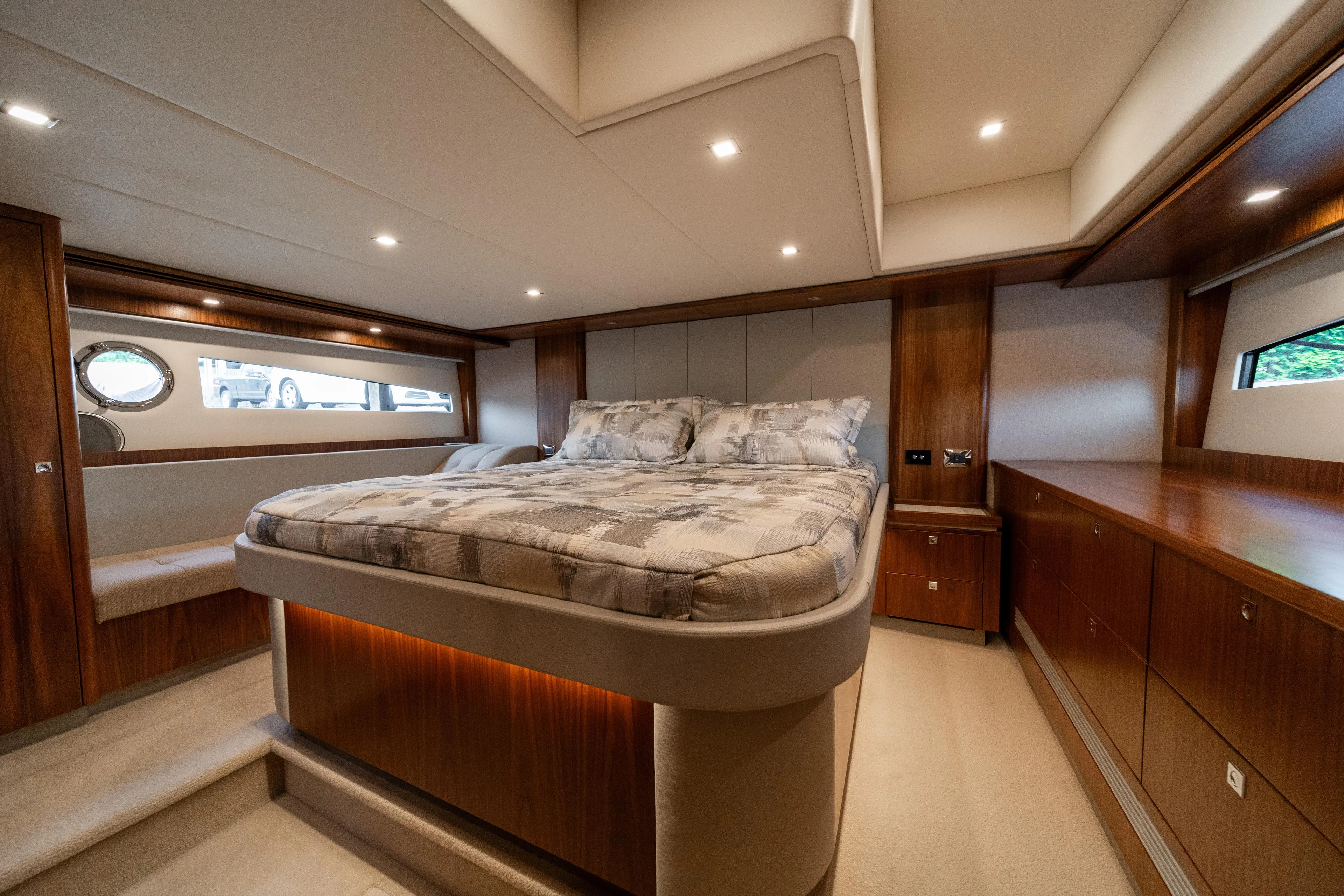 Norfolk Girl Yacht Photos Pics Luxurious bedroom interior of 2018 Riviera 5400 Sport Yacht with elegant wood finishes.