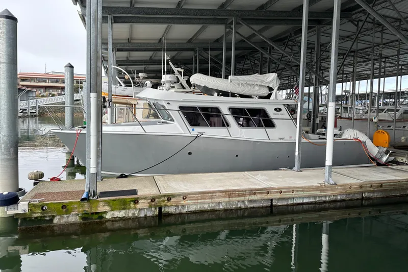 Reel Salty Yacht Photos Pics 2020 Coastal Craft 33 ProFish docked in a covered marina.