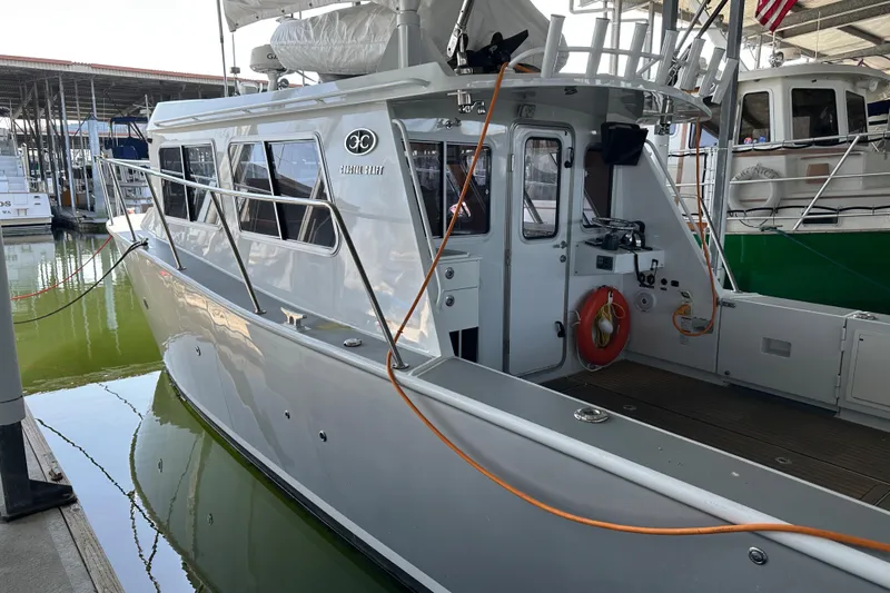 Reel Salty Yacht Photos Pics 2020 Coastal Craft 33 ProFish boat docked in marina, featuring sleek design and modern amenities.