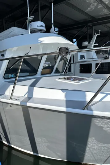 Reel Salty Yacht Photos Pics 2020 Coastal Craft 33 ProFish boat docked in a marina under a metal roof.