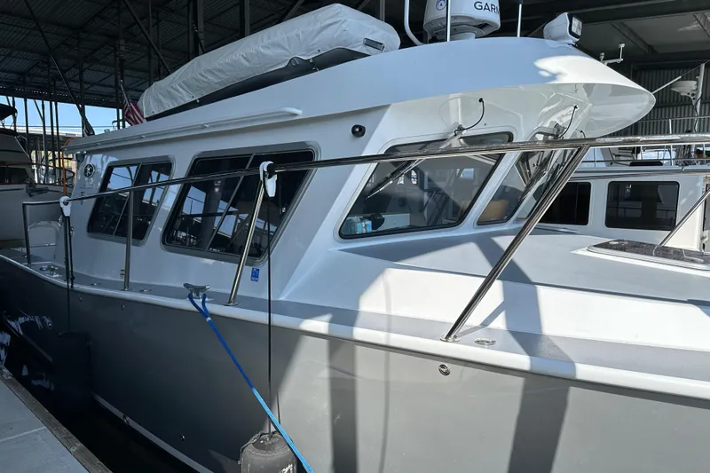 Reel Salty Yacht Photos Pics 2020 Coastal Craft 33 ProFish boat docked in a marina under a covered structure.