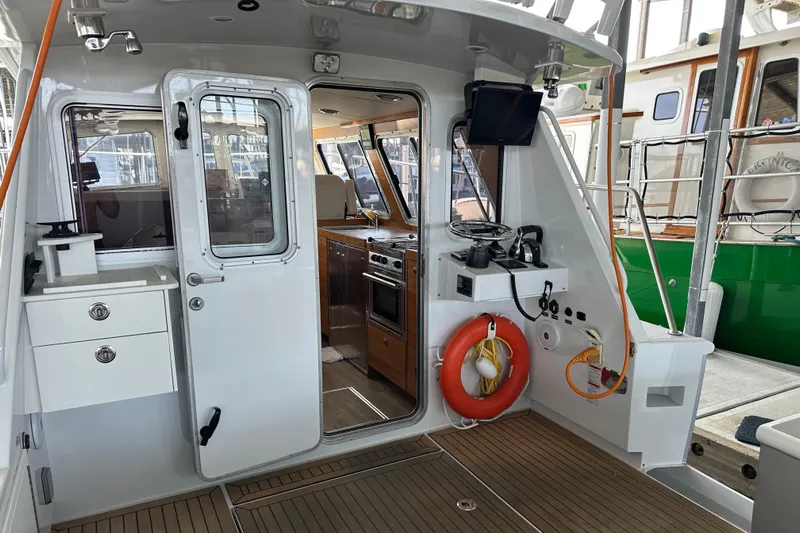 Reel Salty Yacht Photos Pics 2020 Coastal Craft 33 ProFish boat interior with kitchen, life preserver, and navigation equipment.