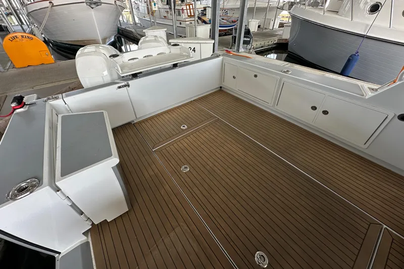 Reel Salty Yacht Photos Pics 2020 Coastal Craft 33 ProFish boat deck with wood finish and storage compartments.