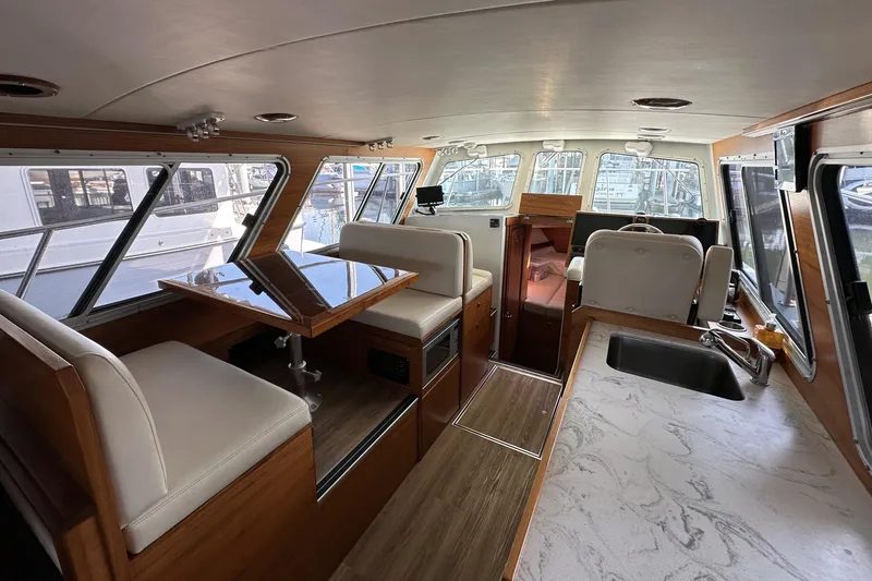 Reel Salty Yacht Photos Pics Interior of 2020 Coastal Craft 33 ProFish boat with modern seating and kitchen area.