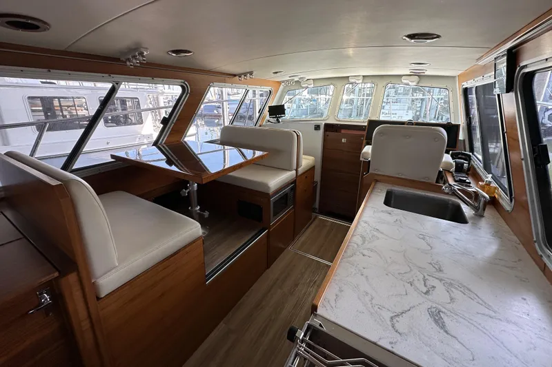 Reel Salty Yacht Photos Pics Interior of 2020 Coastal Craft 33 ProFish boat with modern seating and countertops.