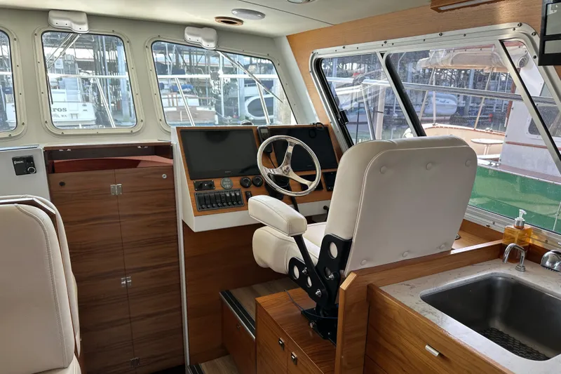 Reel Salty Yacht Photos Pics Interior of 2020 Coastal Craft 33 ProFish boat with helm, seating, and sink.