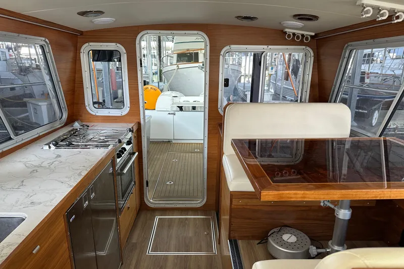 Reel Salty Yacht Photos Pics Interior of 2020 Coastal Craft 33 ProFish boat with wood finish and modern amenities.