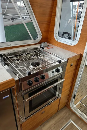 Reel Salty Yacht Photos Pics 2020 Coastal Craft 33 ProFish interior with modern kitchen and stainless steel stove.