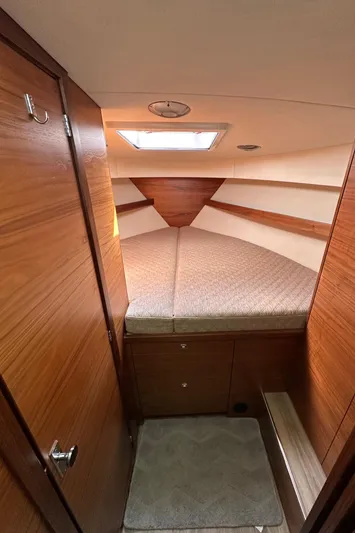 Reel Salty Yacht Photos Pics 2020 Coastal Craft 33 ProFish cabin interior with wood finish and cozy sleeping area.