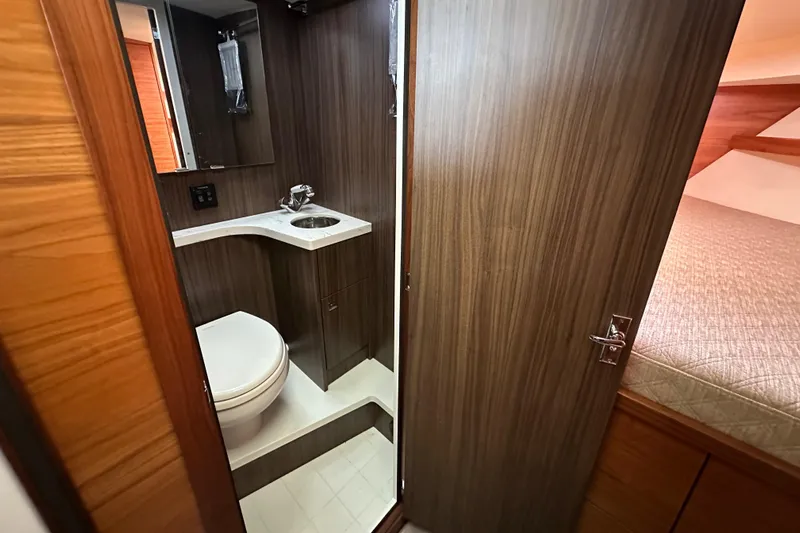 Reel Salty Yacht Photos Pics 2020 Coastal Craft 33 ProFish bathroom interior with modern wood finish and compact design.