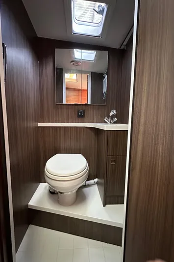 Reel Salty Yacht Photos Pics 2020 Coastal Craft 33 ProFish bathroom with modern wood finish and skylight.