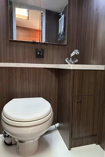 Reel Salty Yacht Photos Pics 2020 Coastal Craft 33 ProFish bathroom with modern wood paneling and compact fixtures.