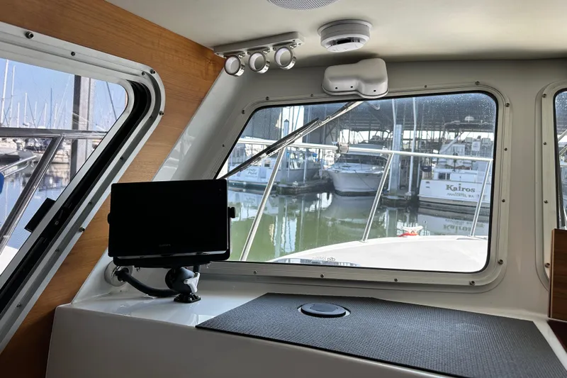Reel Salty Yacht Photos Pics Interior view of 2020 Coastal Craft 33 ProFish boat with marina in background.
