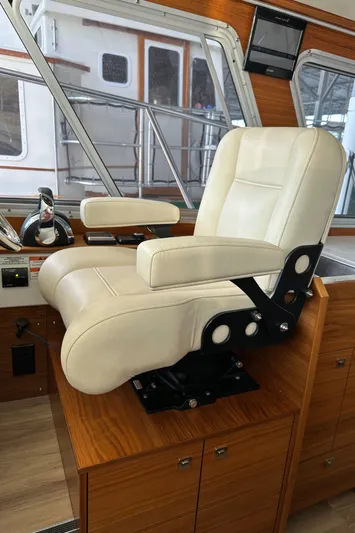 Reel Salty Yacht Photos Pics Captain's chair in 2020 Coastal Craft 33 ProFish boat interior, featuring luxurious design and wood accents.