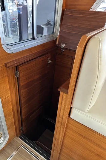 Reel Salty Yacht Photos Pics Interior view of 2020 Coastal Craft 33 ProFish, featuring wooden cabinetry and seating.