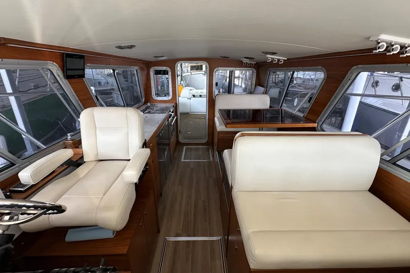 Reel Salty Yacht Photos Pics Interior of 2020 Coastal Craft 33 ProFish with luxurious seating and wood accents.