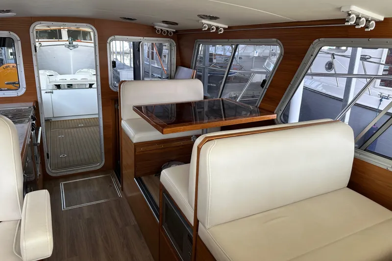 Reel Salty Yacht Photos Pics Interior of 2020 Coastal Craft 33 ProFish with wood accents and white seating.