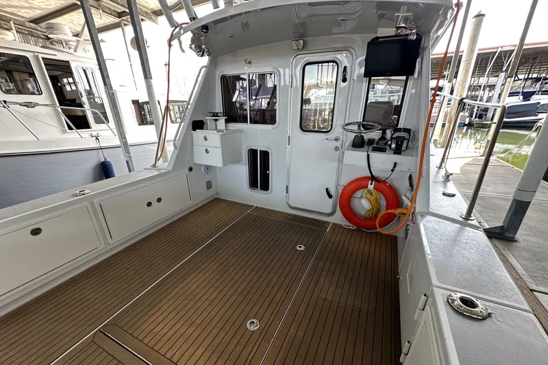 Reel Salty Yacht Photos Pics 2020 Coastal Craft 33 ProFish boat interior with wooden deck and safety equipment.