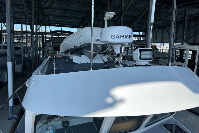 Reel Salty Yacht Photos Pics 2020 Coastal Craft 33 ProFish boat with Garmin radar in a covered marina.