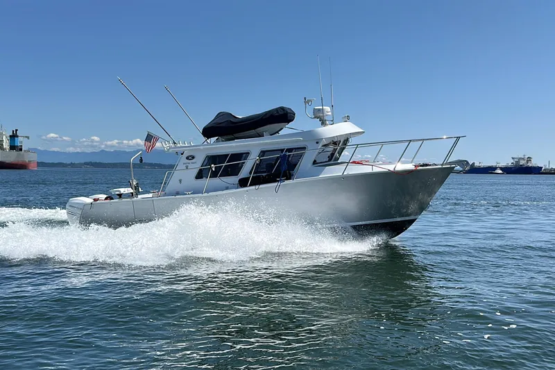 Reel Salty Yacht Photos Pics 2020 Coastal Craft 33 ProFish boat cruising on open water under clear blue sky.