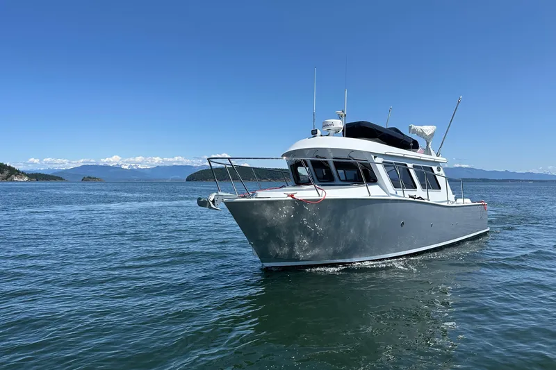 Reel Salty Yacht Photos Pics 2020 Coastal Craft 33 ProFish boat cruising on a clear blue sea.