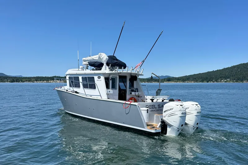 Reel Salty Yacht Photos Pics 2020 Coastal Craft 33 ProFish boat on calm water, featuring dual outboard engines.
