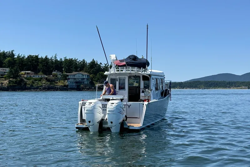 Reel Salty Yacht Photos Pics 2020 Coastal Craft 33 ProFish boat on calm water, scenic coastal backdrop.