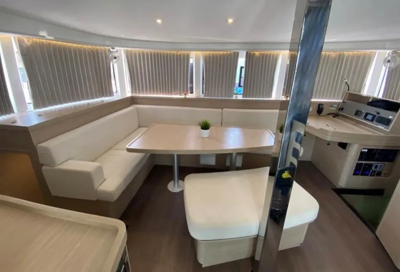  Yacht Photos Pics 2024 Lagoon 42 interior with modern seating, table, and navigation area.