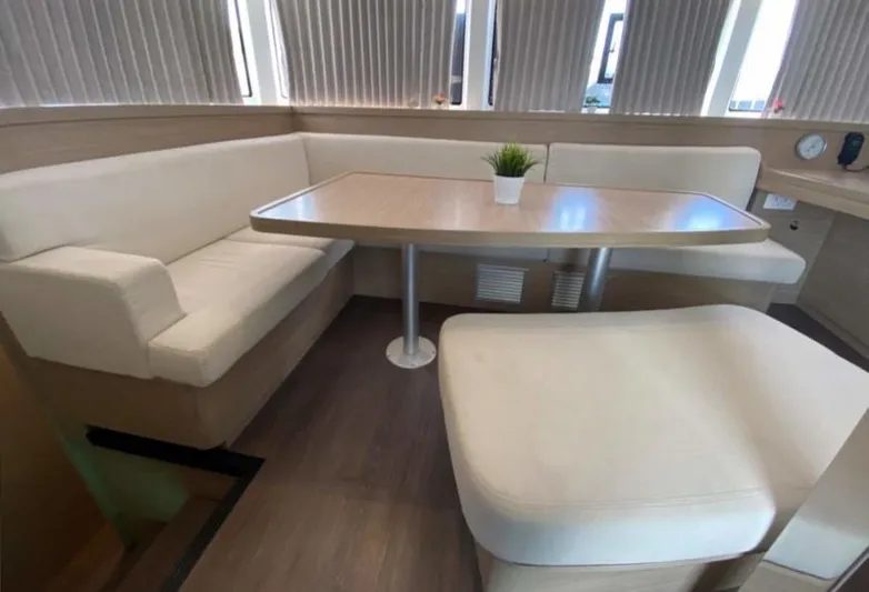  Yacht Photos Pics Luxurious interior of 2024 Lagoon 42 yacht with elegant seating and table.