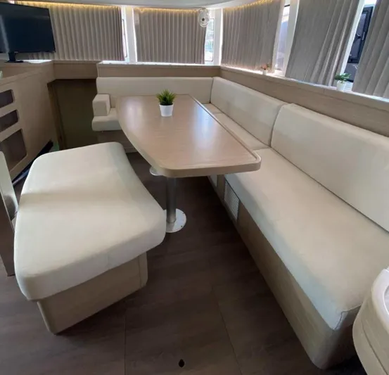  Yacht Photos Pics Luxurious interior of 2024 Lagoon 42 yacht with elegant seating and table.