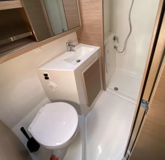  Yacht Photos Pics Modern bathroom in 2024 Lagoon 42 yacht with shower, sink, and toilet.