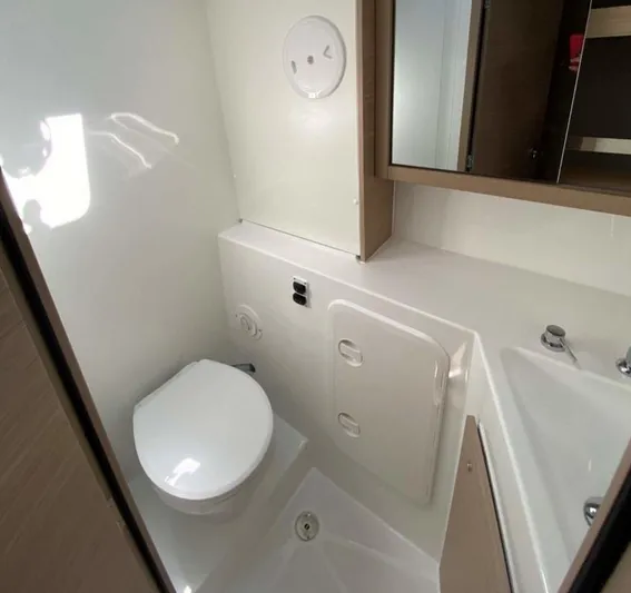  Yacht Photos Pics 2024 Lagoon 42 yacht bathroom with modern fixtures and compact design.