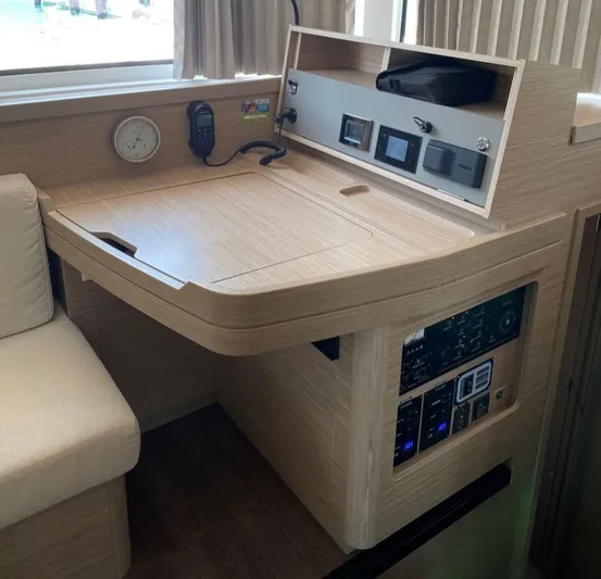  Yacht Photos Pics 2024 Lagoon 42 yacht interior with navigation station and control panel.