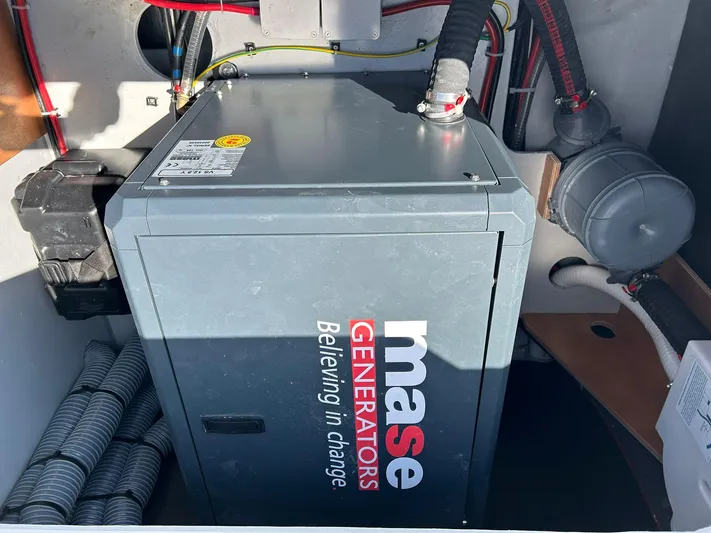  Yacht Photos Pics Mase generator in a 2024 Lagoon 42 yacht engine room, featuring wiring and ventilation.
