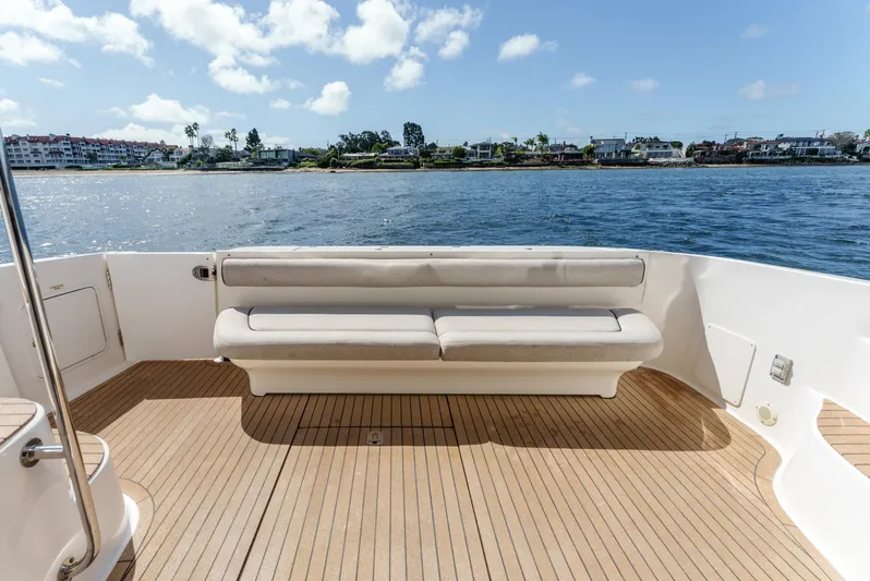  Yacht Photos Pics 2005 Sea Ray 550 Sedan Bridge yacht deck with seating, overlooking calm waters.