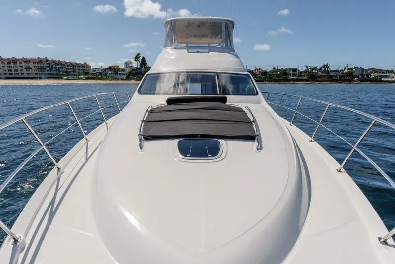  Yacht Photos Pics 2005 Sea Ray 550 Sedan Bridge yacht on calm water, clear sky background.