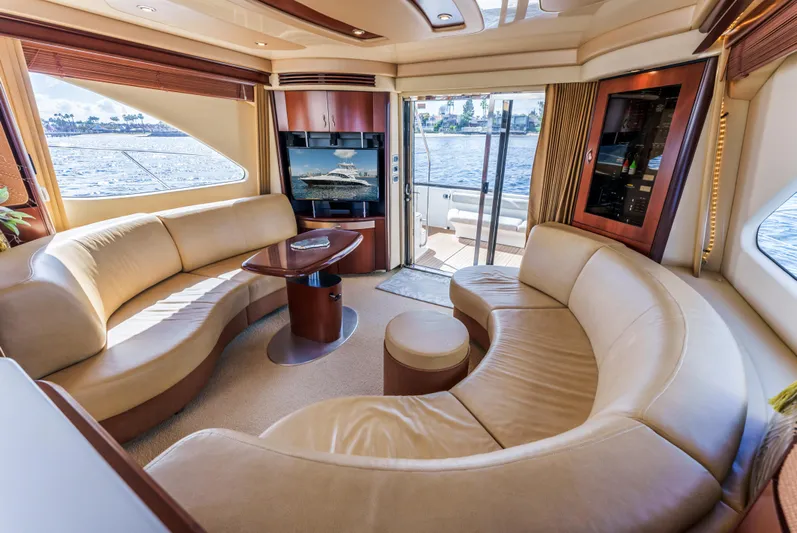  Yacht Photos Pics Luxurious interior of 2005 Sea Ray 550 Sedan Bridge yacht with curved seating and scenic views.