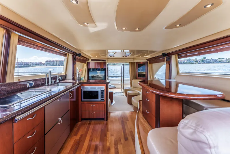  Yacht Photos Pics Luxurious interior of 2005 Sea Ray 550 Sedan Bridge yacht with modern kitchen and seating.