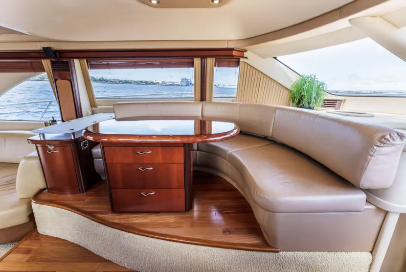  Yacht Photos Pics Luxurious interior of 2005 Sea Ray 550 Sedan Bridge yacht with leather seating and wooden table.