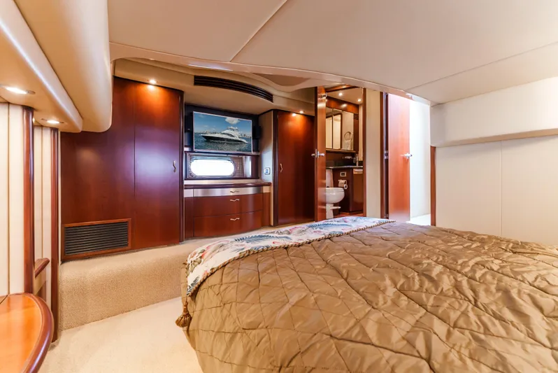  Yacht Photos Pics Luxurious 2005 Sea Ray 550 Sedan Bridge yacht interior with cozy bedroom and elegant wood finishes.