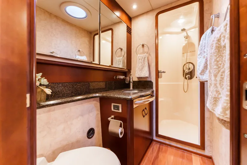  Yacht Photos Pics Luxurious bathroom in 2005 Sea Ray 550 Sedan Bridge yacht with shower and wood accents.