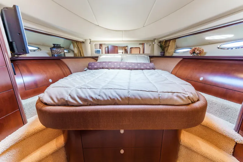  Yacht Photos Pics Luxurious 2005 Sea Ray 550 Sedan Bridge yacht bedroom with elegant wood finishes.
