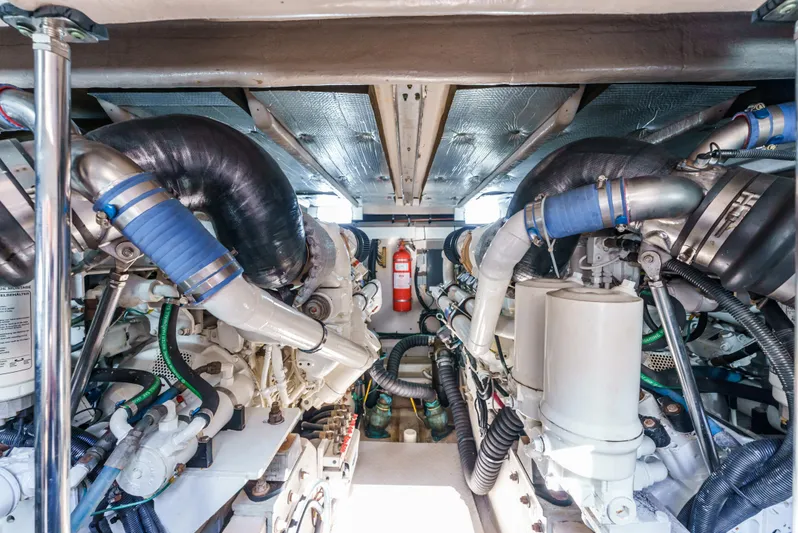  Yacht Photos Pics Engine room of 2005 Sea Ray 550 Sedan Bridge with visible machinery and fire extinguisher.