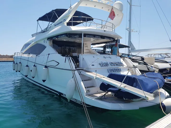 Tais Octavia Yacht Photos Pics Luxury 2005 Sunseeker 75 yacht docked in marina, featuring sleek design and spacious deck.