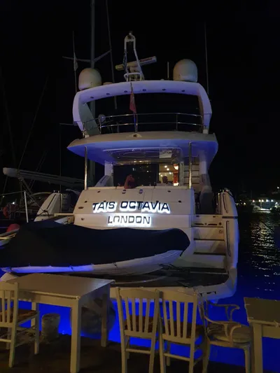 Tais Octavia Yacht Photos Pics Luxury Sunseeker 75 yacht docked at night, illuminated with blue lights, 2005 model.
