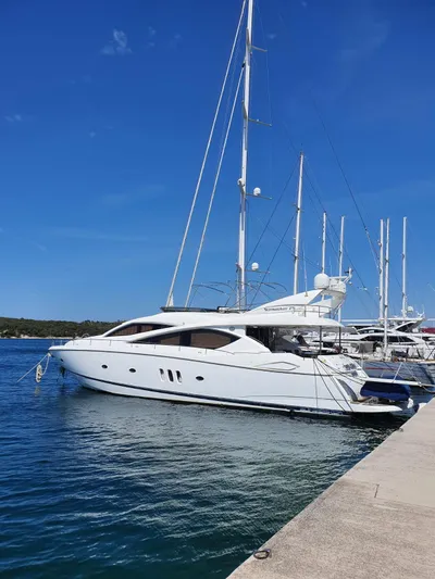 Tais Octavia Yacht Photos Pics 2005 Sunseeker 75 yacht docked at marina under clear blue sky.