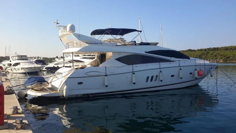 Tais Octavia Yacht Photos Pics Luxury 2005 Sunseeker 75 yacht docked at marina, calm waters, clear sky.