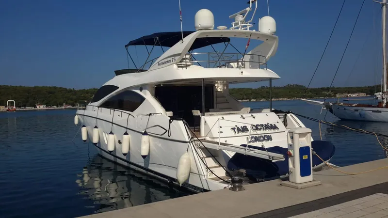 Tais Octavia Yacht Photos Pics 2005 Sunseeker 75 yacht docked at a marina, featuring sleek design and modern amenities.