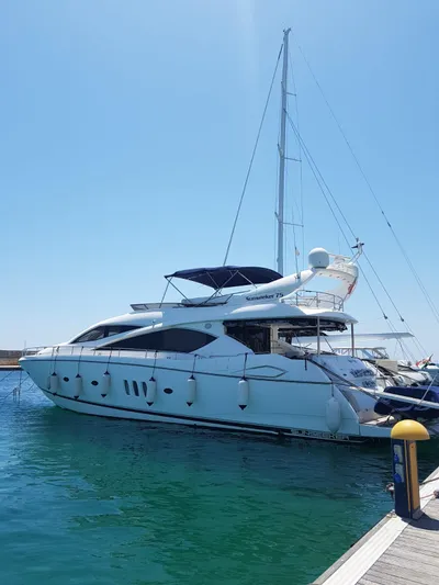 Tais Octavia Yacht Photos Pics 2005 Sunseeker 75 yacht docked in a marina under clear blue skies.