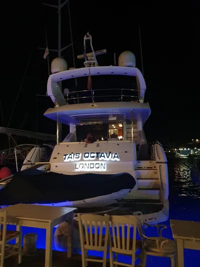 Tais Octavia Yacht Photos Pics Luxury Sunseeker 75 yacht docked at night, illuminated with blue lights, 2005 model.